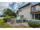 View of the back of house, landscaped yard, satellite dishes, and mature trees at 1419 Red Mountain Dr # 126, Longmont, CO 80504