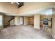 Spacious living room flows into dining area and kitchen with carpeted floor and open plan at 1419 Red Mountain Dr # 126, Longmont, CO 80504