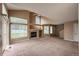 Open living room boasts vaulted ceilings, a fireplace, and large windows and carpeted floor at 1419 Red Mountain Dr # 126, Longmont, CO 80504