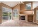 Bright, open living room with vaulted ceiling, fireplace, and sliding door to patio and carpeted floor at 1419 Red Mountain Dr # 126, Longmont, CO 80504