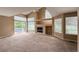 Bright living room boasts vaulted ceilings, fireplace, and access to the patio area and open floorplan at 1419 Red Mountain Dr # 126, Longmont, CO 80504