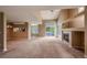 Expansive living room with a fireplace, large windows, and open floorplan and carpeted floor at 1419 Red Mountain Dr # 126, Longmont, CO 80504