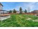 Open back yard with healthy grass and wood fence that provides privacy at 600 Balsa Dr, Castle Rock, CO 80104