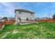A large backyard with green grass and a wooden fence surrounds the property and a deck at 600 Balsa Dr, Castle Rock, CO 80104