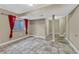 Spacious basement area with tile flooring, red curtains, and ample space at 600 Balsa Dr, Castle Rock, CO 80104