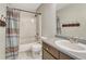 Bathroom with a shower-tub combo, vanity, and decorative shower curtain at 600 Balsa Dr, Castle Rock, CO 80104