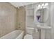 Tiled bathroom features a tub/shower, toilet, sink, and vanity cabinet at 600 Balsa Dr, Castle Rock, CO 80104