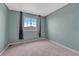 Bedroom with neutral walls and carpet with a window overlooking the neighborhood at 600 Balsa Dr, Castle Rock, CO 80104