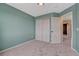 Bedroom features neutral walls and carpet with closet and view to hallway and other rooms at 600 Balsa Dr, Castle Rock, CO 80104