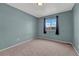Cozy bedroom with neutral colored walls and carpet and a window to let in light at 600 Balsa Dr, Castle Rock, CO 80104