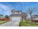 Charming two-story home with a well-maintained lawn and a two car garage on a sunny day at 600 Balsa Dr, Castle Rock, CO 80104