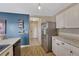 Kitchen area with stainless steel refrigerator and view of hallway with access to doors at 600 Balsa Dr, Castle Rock, CO 80104