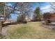 The backyard features a large lawn, and a wood privacy fence at 7636 S Allison Ct, Littleton, CO 80128