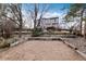 Multi-tiered backyard design with rock accents, mature trees, and partial fencing for privacy at 7636 S Allison Ct, Littleton, CO 80128