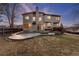 Backyard view featuring a patio, deck and lawn surrounded by a wooden fence at 7636 S Allison Ct, Littleton, CO 80128