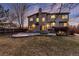 Exterior view of the backyard showing a patio, deck and well maintained lawn at 7636 S Allison Ct, Littleton, CO 80128