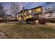 Exterior view of the backyard featuring a well maintained lawn with patio and deck at 7636 S Allison Ct, Littleton, CO 80128