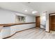 Finished basement with light wood flooring, a built in desk and a window providing natural light at 7636 S Allison Ct, Littleton, CO 80128