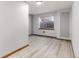 Finished basement showcasing neutral walls and light wood laminate flooring at 7636 S Allison Ct, Littleton, CO 80128