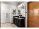 Bathroom with double vanity, large mirror, and a light fixture at 7636 S Allison Ct, Littleton, CO 80128