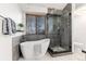 Bathroom featuring a freestanding tub and a tiled glass shower at 7636 S Allison Ct, Littleton, CO 80128