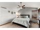 Bedroom with a patterned bedspread, a ceiling fan, and a window with blinds at 7636 S Allison Ct, Littleton, CO 80128