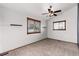Bedroom with neutral carpet, two windows, and a ceiling fan at 7636 S Allison Ct, Littleton, CO 80128