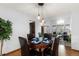 Cozy dining room with modern lighting fixture and stylish table setting at 7636 S Allison Ct, Littleton, CO 80128