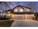 Charming two-story home features a three-car garage, stone accents and neutral stucco at 7636 S Allison Ct, Littleton, CO 80128