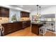 Modern kitchen featuring dark wood cabinets, laminate floors and stainless steel appliances at 7636 S Allison Ct, Littleton, CO 80128