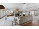 Bright living room featuring a stone fireplace, neutral decor, and French doors at 7636 S Allison Ct, Littleton, CO 80128