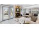 Cozy living room featuring a stone fireplace, and French doors to the backyard at 7636 S Allison Ct, Littleton, CO 80128