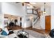 Spacious living room featuring an open layout, stairs, and access to a dining area at 7636 S Allison Ct, Littleton, CO 80128
