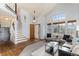 Open living room with hardwood floors, stairway, natural light, and comfortable seating arrangement at 7636 S Allison Ct, Littleton, CO 80128