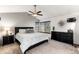 Comfortable main bedroom with high ceilings, ceiling fan, neutral colors and great light at 7636 S Allison Ct, Littleton, CO 80128