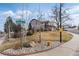 Street view of a home with a grassy yard, mature trees, and proximity to a street corner at 7636 S Allison Ct, Littleton, CO 80128