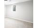 This is an empty basement with carpeting, base trim, and a window for natural light at 4300 Osage St, Denver, CO 80211