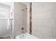 Modern bathroom features a tiled shower with a rainfall showerhead, tub, and stylish fixtures at 4300 Osage St, Denver, CO 80211