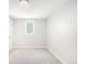 A bright bedroom with neutral carpet, fresh paint, and a window at 4300 Osage St, Denver, CO 80211