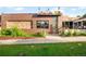 Brick commercial building with a prominent sign and modern architectural details, set amidst lush greenery at 4300 Osage St, Denver, CO 80211