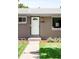 Inviting single-Gathering home showcases a well-manicured lawn and charming white front door with a window detail and black trim at 4300 Osage St, Denver, CO 80211