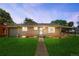 Charming brick home featuring a lush green lawn and walkway leading to the front door at 4300 Osage St, Denver, CO 80211