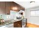 Modern kitchen with stainless steel appliances, granite countertops, and stylish backsplash at 4300 Osage St, Denver, CO 80211