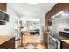 Well-lit kitchen featuring stainless steel appliances, granite countertops, and an open view to the living room at 4300 Osage St, Denver, CO 80211