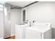 Laundry room area with a side-by-side washer and dryer on wood floors at 4300 Osage St, Denver, CO 80211