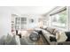 Bright living room featuring hardwood floors, large windows, and comfortable seating at 4300 Osage St, Denver, CO 80211