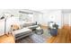 Open-concept living room with hardwood floors, modern lighting, and comfortable seating at 4300 Osage St, Denver, CO 80211
