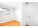 Empty room with hookups for washer and dryer; features window, hardwood floors, and neutral walls at 4300 Osage St, Denver, CO 80211