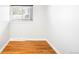 Empty room features hardwood floors, neutral walls, and a window with blinds at 4300 Osage St, Denver, CO 80211
