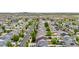 An aerial view showing houses in a neighborhood with green trees lining the streets and homes with solar panels at 5536 Kirk St, Denver, CO 80249